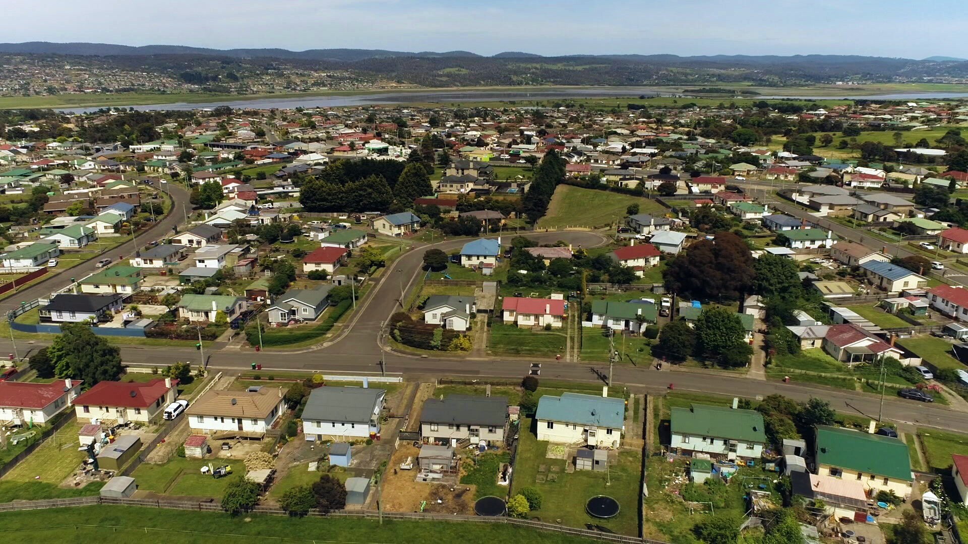 An aerial view over the rooftops of houses.