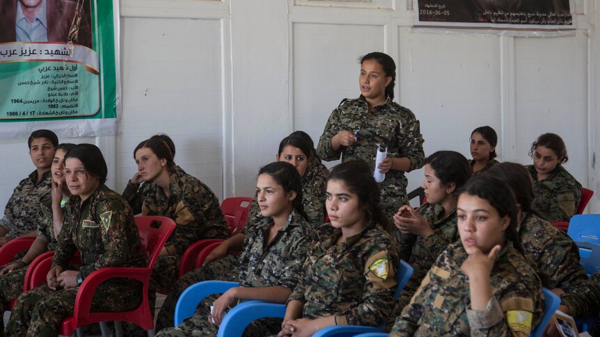 17-year old Amara, from Raqqa, talks as she attends a history class