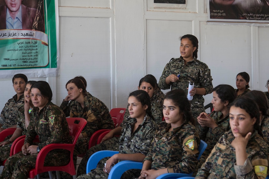 17-year old Amara, from Raqqa, talks as she attends a history class