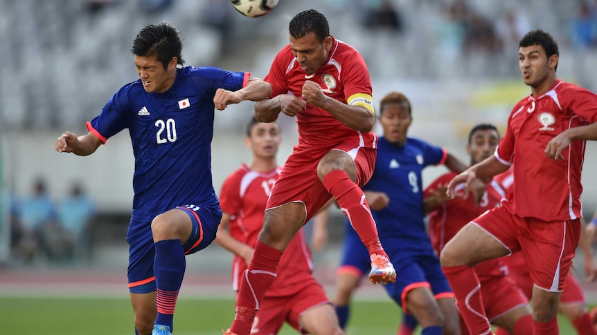 Naomichi battles for possession with Palestine players
