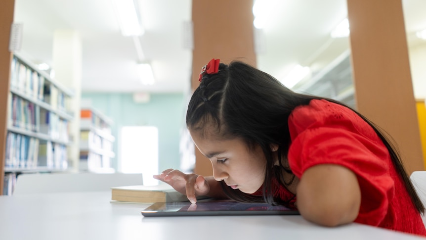 a girl scrolling close to a tablet device