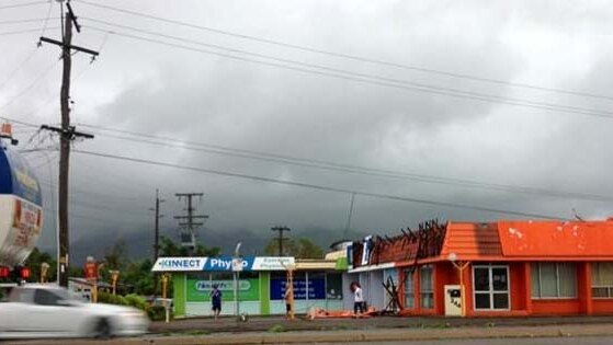 Shops and powerlines are damaged in Townsville, north Queensland, after a 'mini-tornado'
