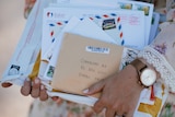 A bundle of letters held by lady