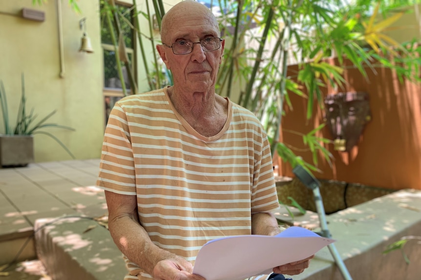 Remote teacher Jeff Aschmann holding a letter he has written to the Northern Territory government asking for a health assessment