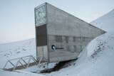 A large rectangular building built into the side of a snowy mountain in Norway.