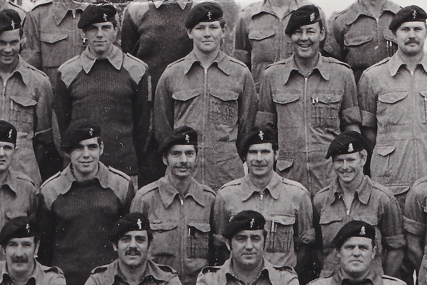 A black and white image of servicemen standing for a photoshoot.