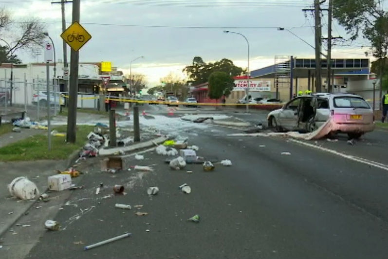 Wreckage is strewn across a road.