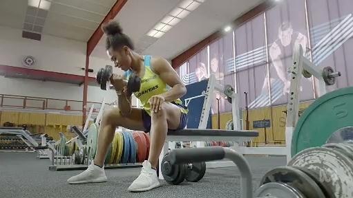 Woman lifts weights in gym