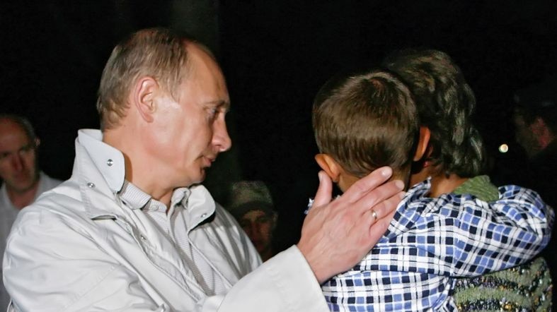 Russian PM Vladimir Putin comforts with South Ossetian refugees