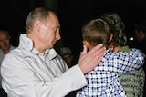 Vladimir Putin comforts South Ossetian refugees who fled the fighting.