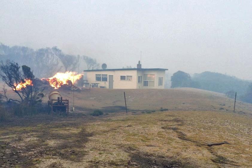 Flames behind a shack at Nelson Bay