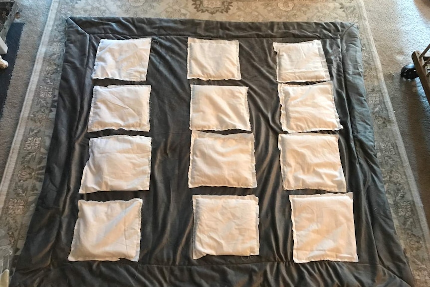 Back of a weighted blanket being made showing the pockets of weighted materials