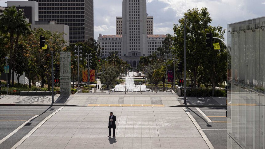 A lone pedestrian crosses Grand Avenue in Los Angeles