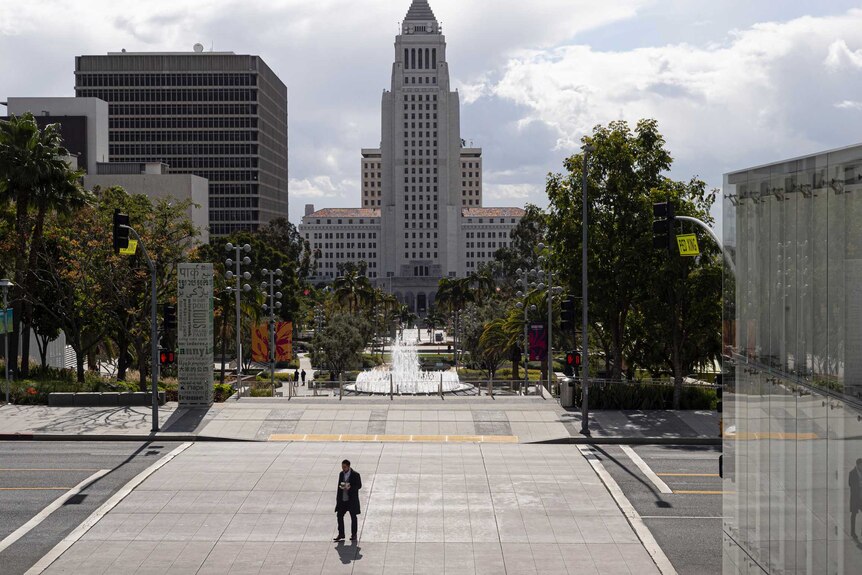 A lone pedestrian crosses Grand Avenue in Los Angeles