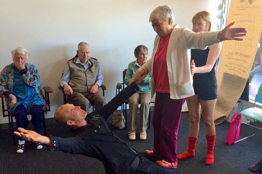 Aged care residents in Ulverstone watch on as a circus performer teaches circus tricks.