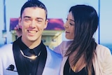 A young man in formal wear poses with his mother.