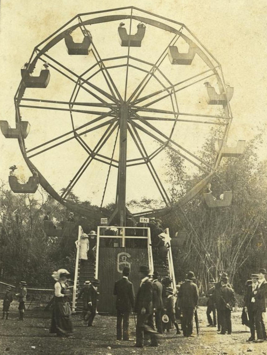 A black and white photo of a Ferris wheel.