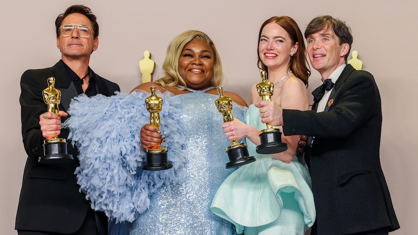 The four actors and actresses smile and pose for a photo, each holding up their gold Oscars statue.