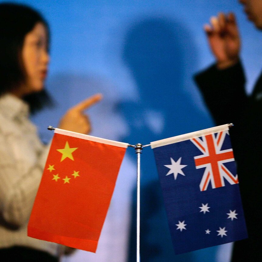 A Chinese and Australian flag o a conference table