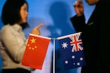 A Chinese and Australian flag o a conference table