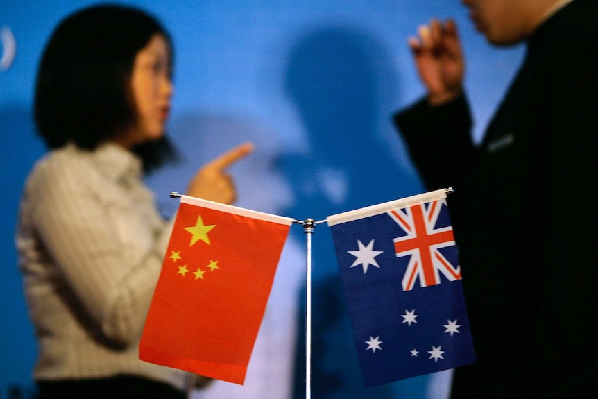 Chinese and Australian flags on a conference table