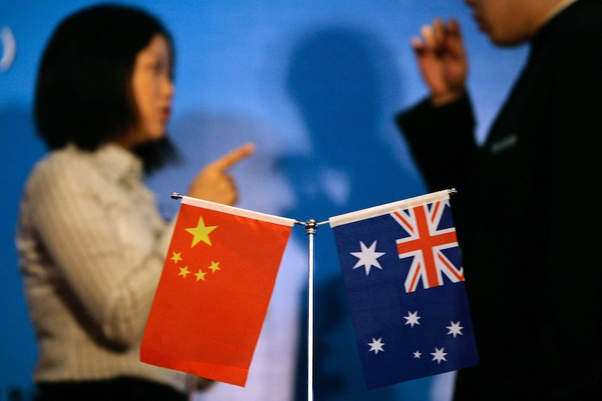 A Chinese and Australian flag o a conference table