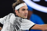 Roger Federer returns against Kei Nishikori