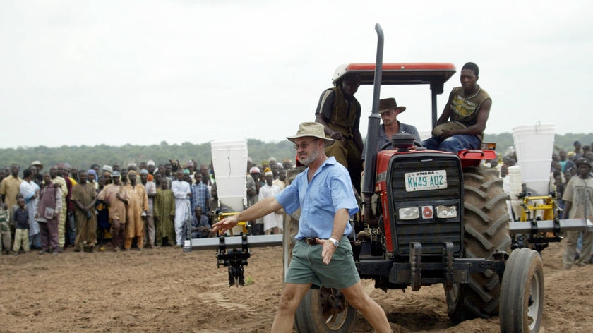 A White Zimbabwean farmers direct tractors on a Nigerian farm