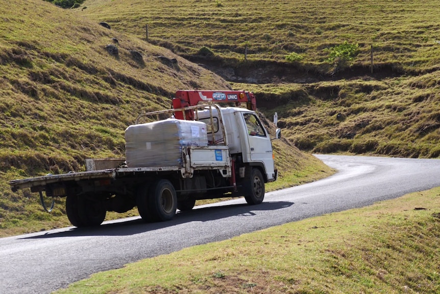 A truck travels along Cascade Road past its iconic rolling hills.