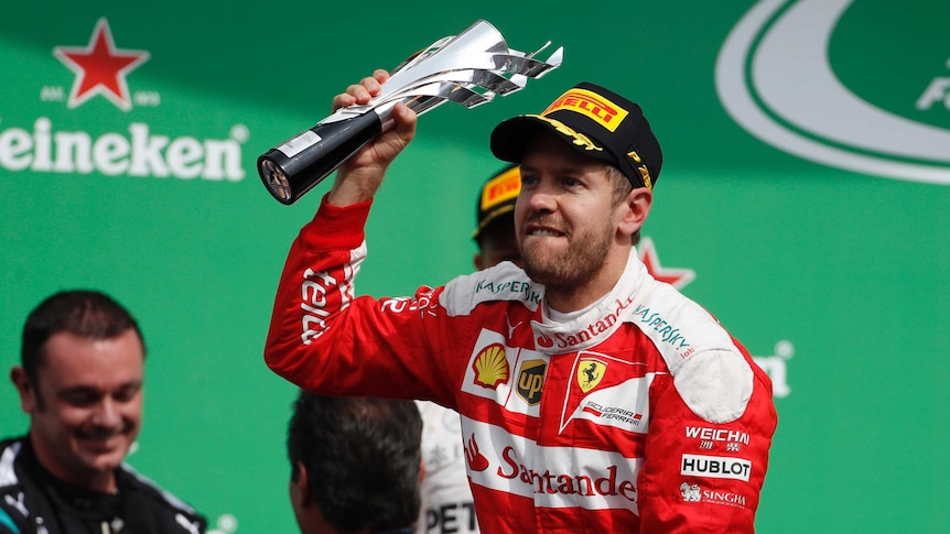 Sebastian Vettel with his third-place trophy in Mexico