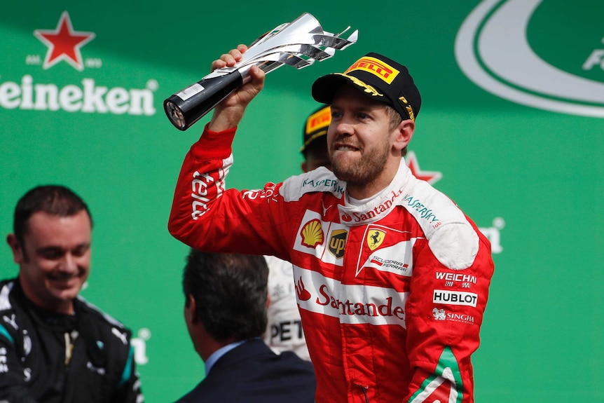 Sebastian Vettel with his third-place trophy in Mexico