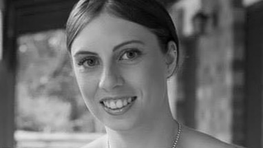 Black and white wedding photo of murder victim Kelly Wilkinson smiling.