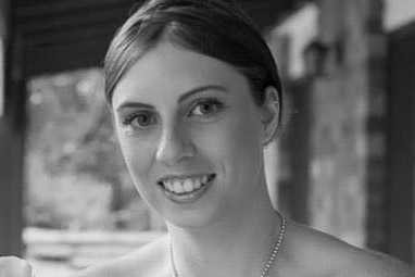 Black and white wedding photo of murder victim Kelly Wilkinson smiling.