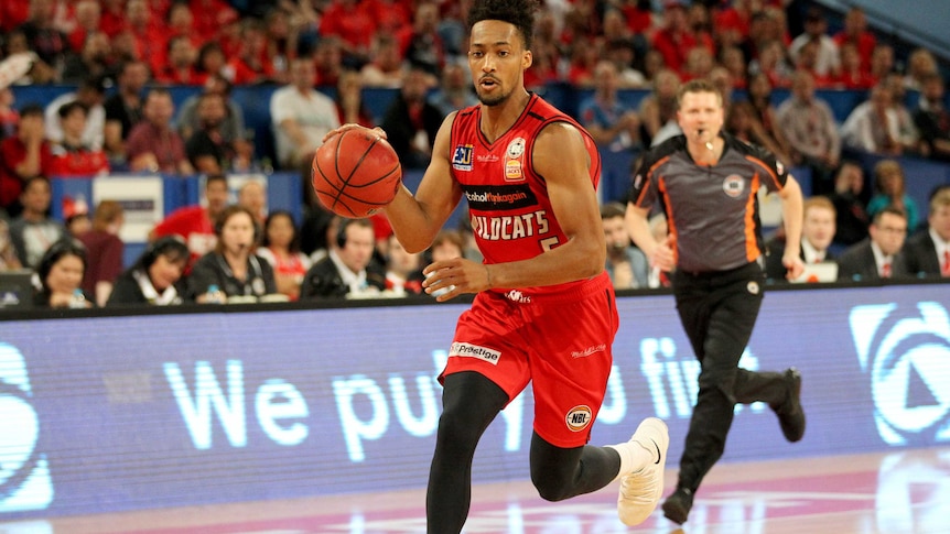 Jean-Pierre Tokoto of the Perth Wildcats grip the ball during a match at Perth arena.