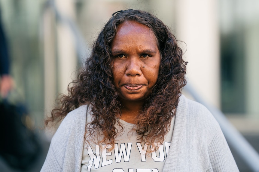 An Aboriginal woman in a grey cardigan