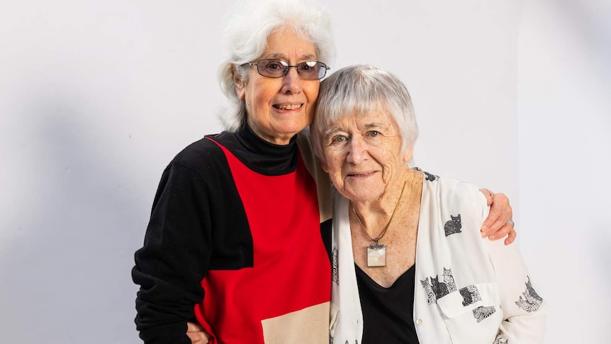 Phyllis Papps and Francesca Curtis pose for a photo against a white backdrop.