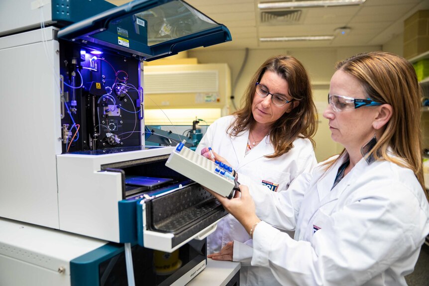 Prof Michelle Colgrave with a mass spectrometer.