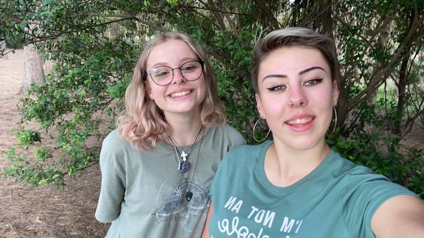 Liv and a young friend are wearing light green tshirts and smiling for a selfie.