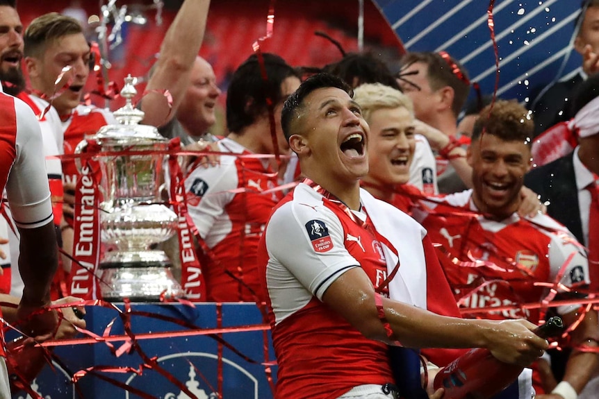 Alexis Sanchez spray champagne after winning the FA Cup.