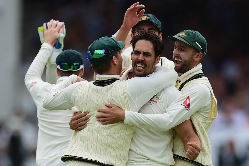 Mitchell Johnson is congratulated after taking the wicket of Joe Root