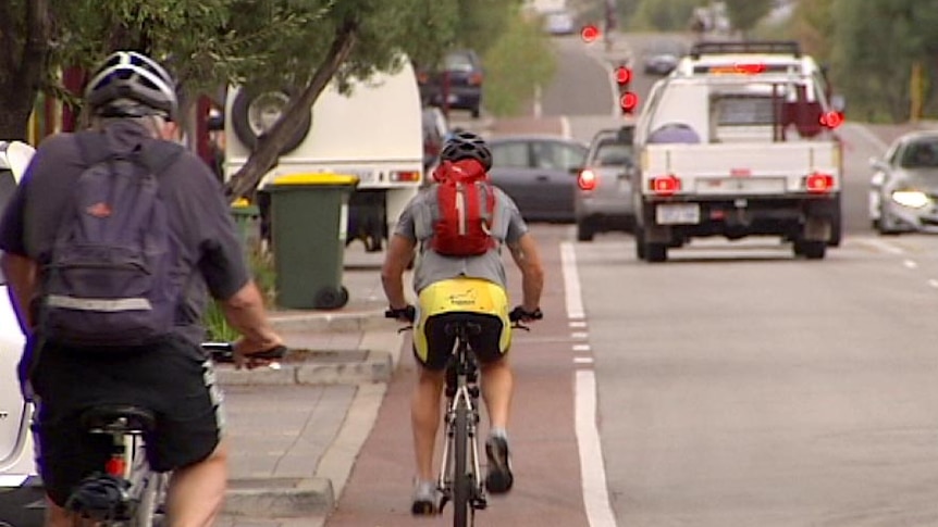 Cyclists share city road with cars