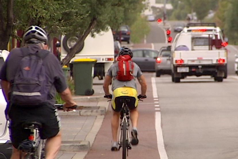 Cyclists share city road with cars
