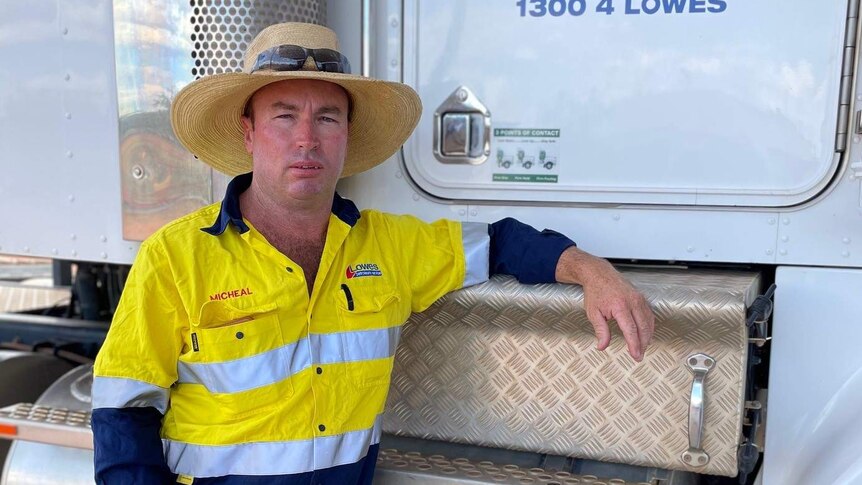 Truck driver Michael Thompson who saved the life of a man he discovered stranded on an outback road, standing beside his truck