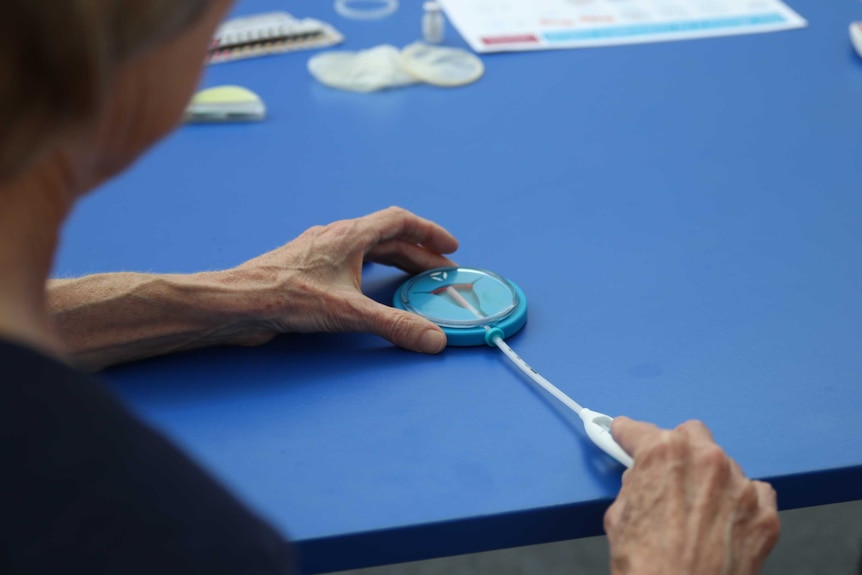 Medical testing work being performed on a blue table