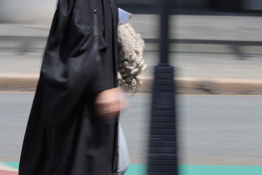 Barrister in robes outside court walking in Brisbane street