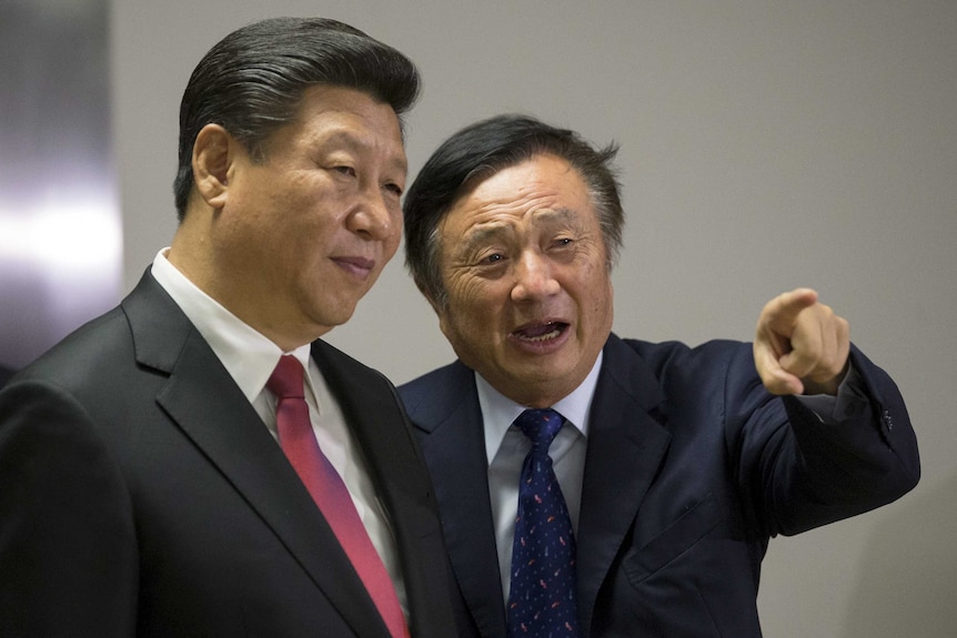 Chinese President Xi Jinping pauses as Ren Zhengfei shows him around Huawei's London offices, Mr Ren is pointing at something.