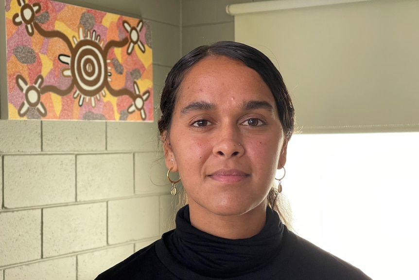 A young Indigenous woman looking at the camera