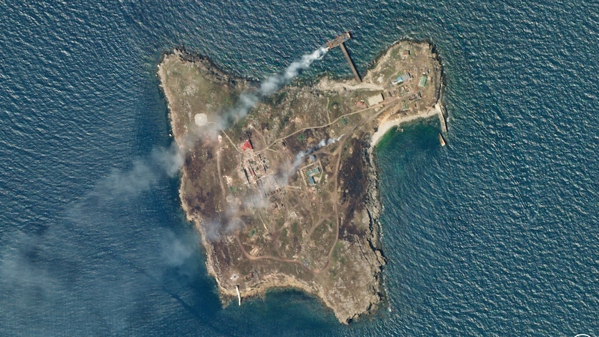 A satellite image shows smoke rising from Snake Island