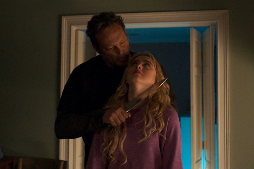 A scene from the movie Freaky with Kathryn Newton being menaced by Vince Vaughn