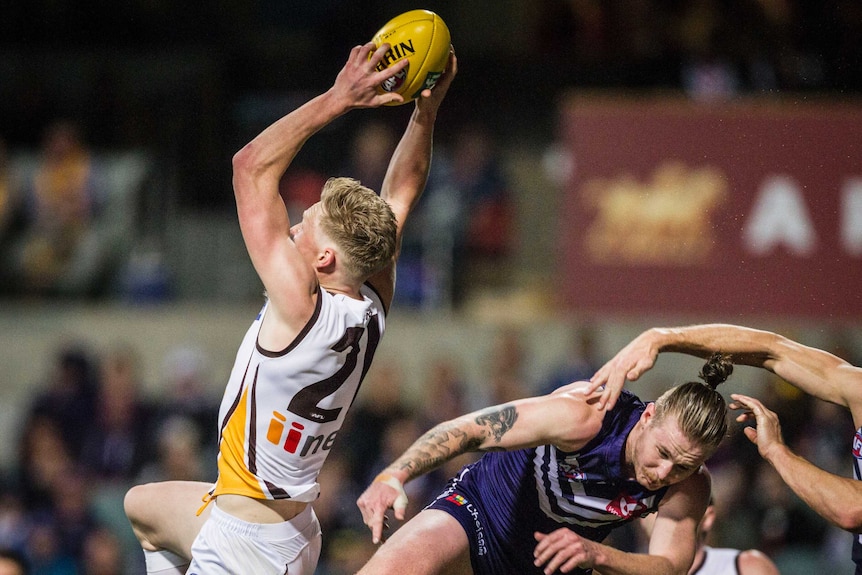 James Sicily of the Hawks takes a mark against Fremantle at Subiaco Oval.